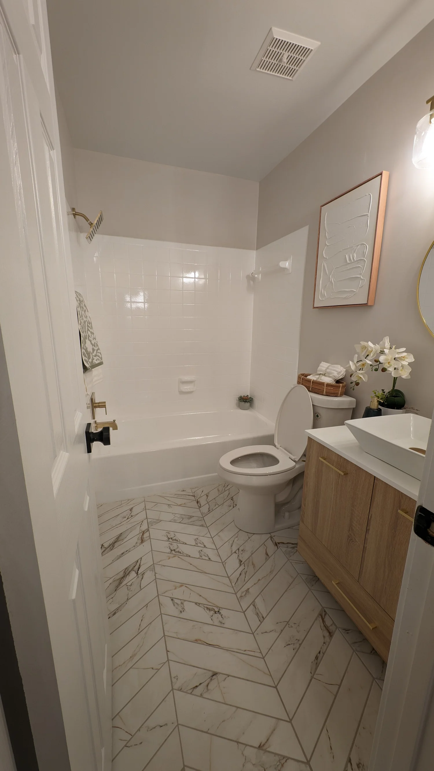 Completed JPR bathroom renovation with white tile and modern fixtures